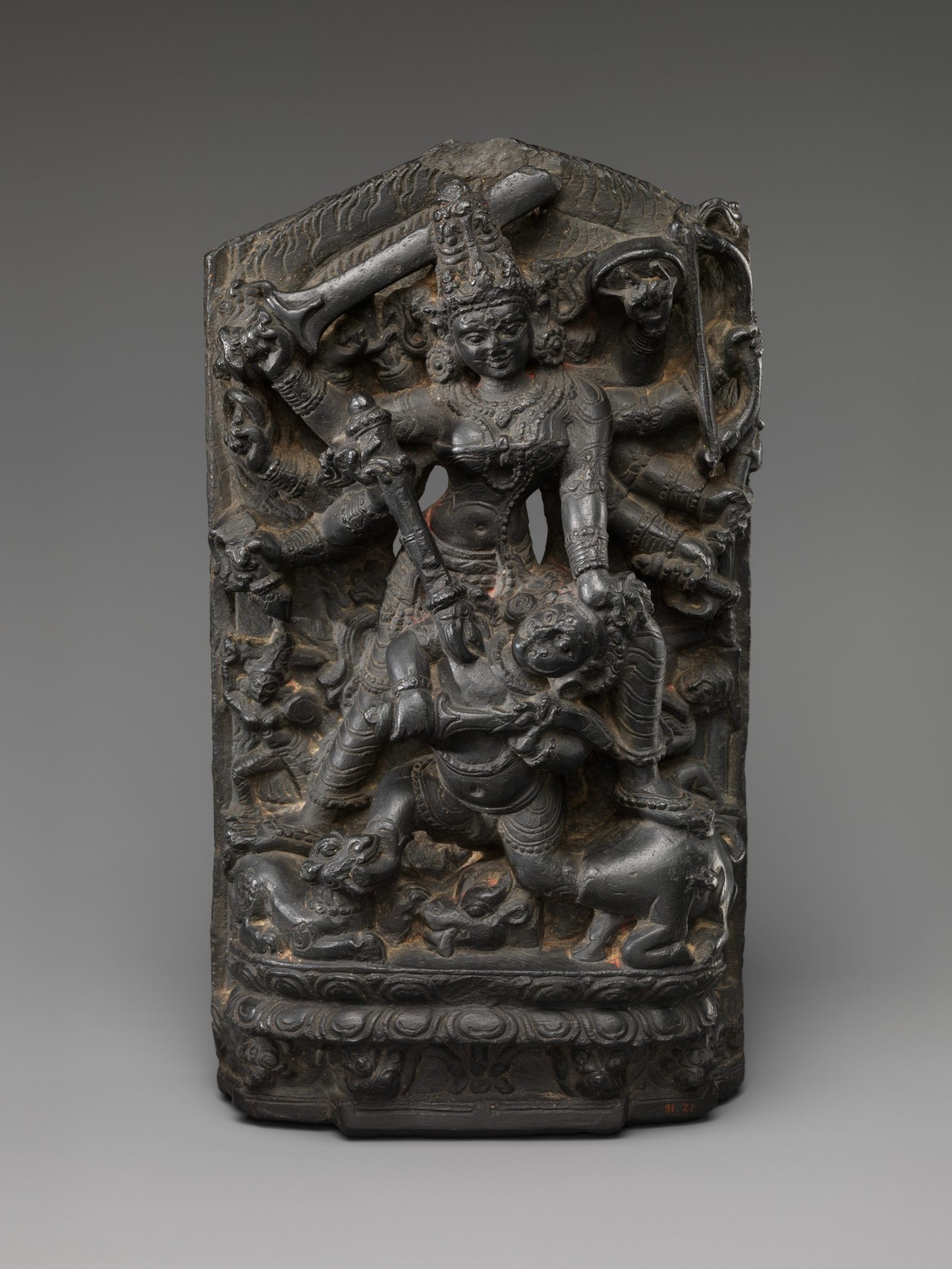 Stone sculpture of multi-armed Durga defeating Mahishasura.