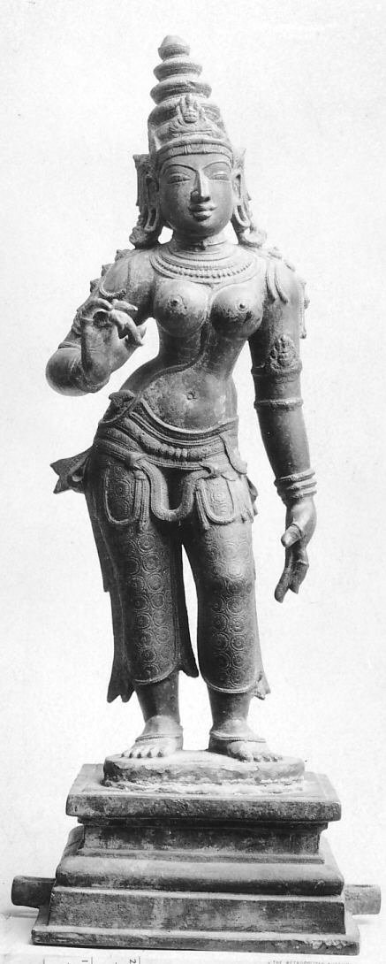 Standing bronze sculpture of Parvati with a tall crown and one hand raised.