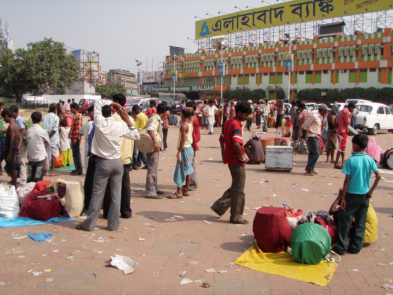 Drummers gather with large decorated dhaak drums and bags outside Sealdah railway station in Kolkata.