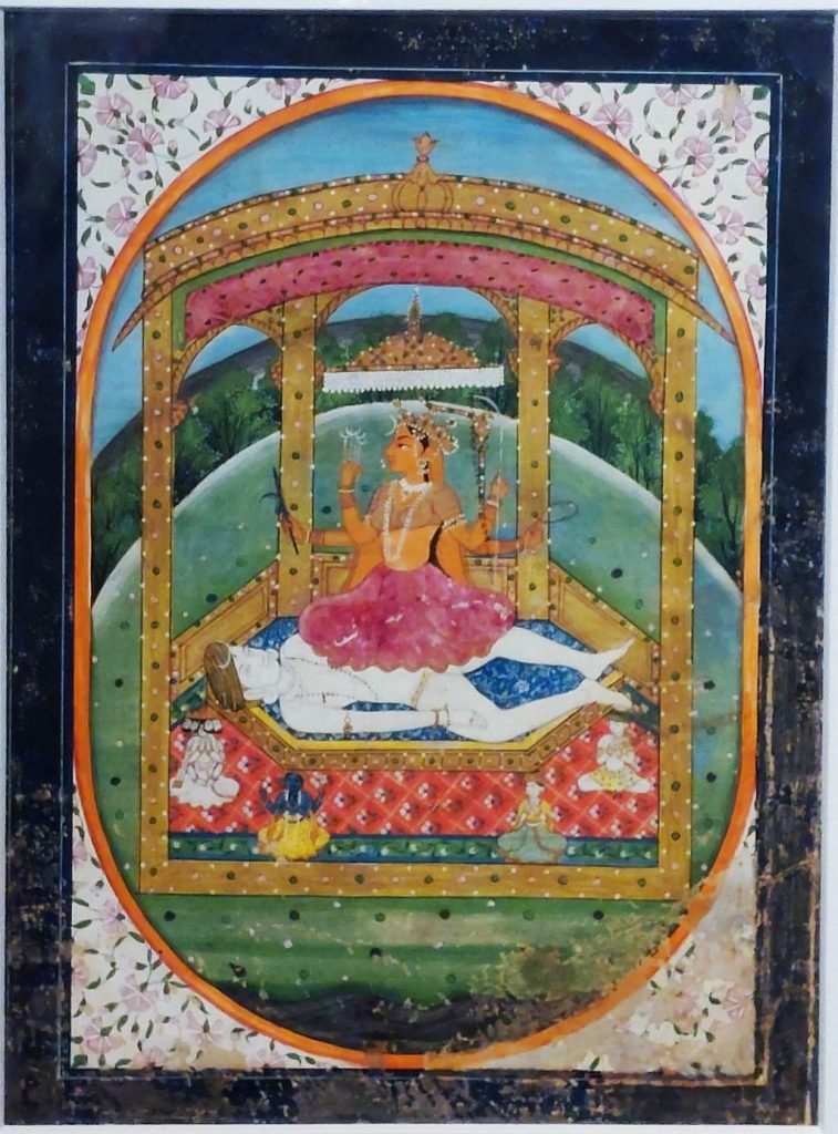 Rajasthani painting of four-armed Tripurasundari seated above a reclining figure beneath an ornate canopy, with a bow, arrows and smaller figures below.